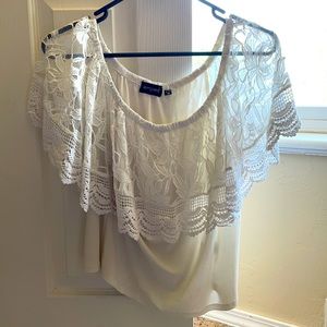 A top lace blouse , wide in the shoulder area
